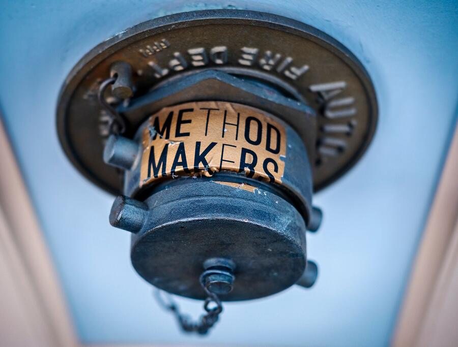 A pendent sprinkler head seen close up against a ceiling